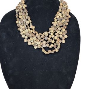 BOHO MULTI  STRAND BROWN AND TAN WOODEN LIKE BEADS WITH LARGER BEADS IN BACK